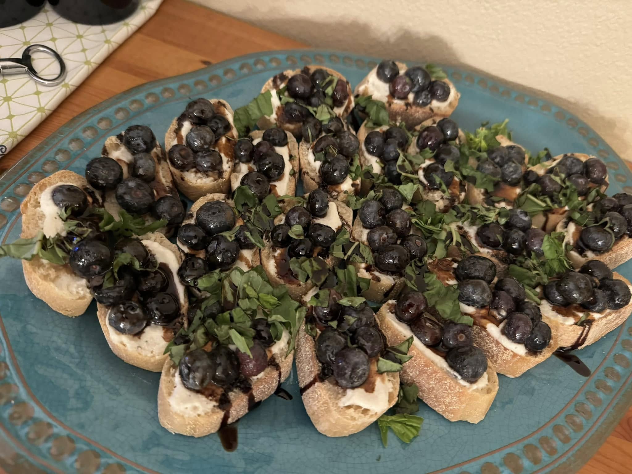 Blueberry lemon ricotta bruschetta topped with fresh basil and balsamic glaze